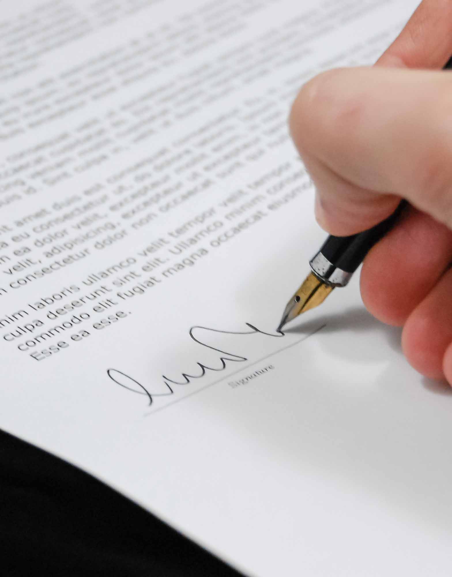 A picture of someone signing a document